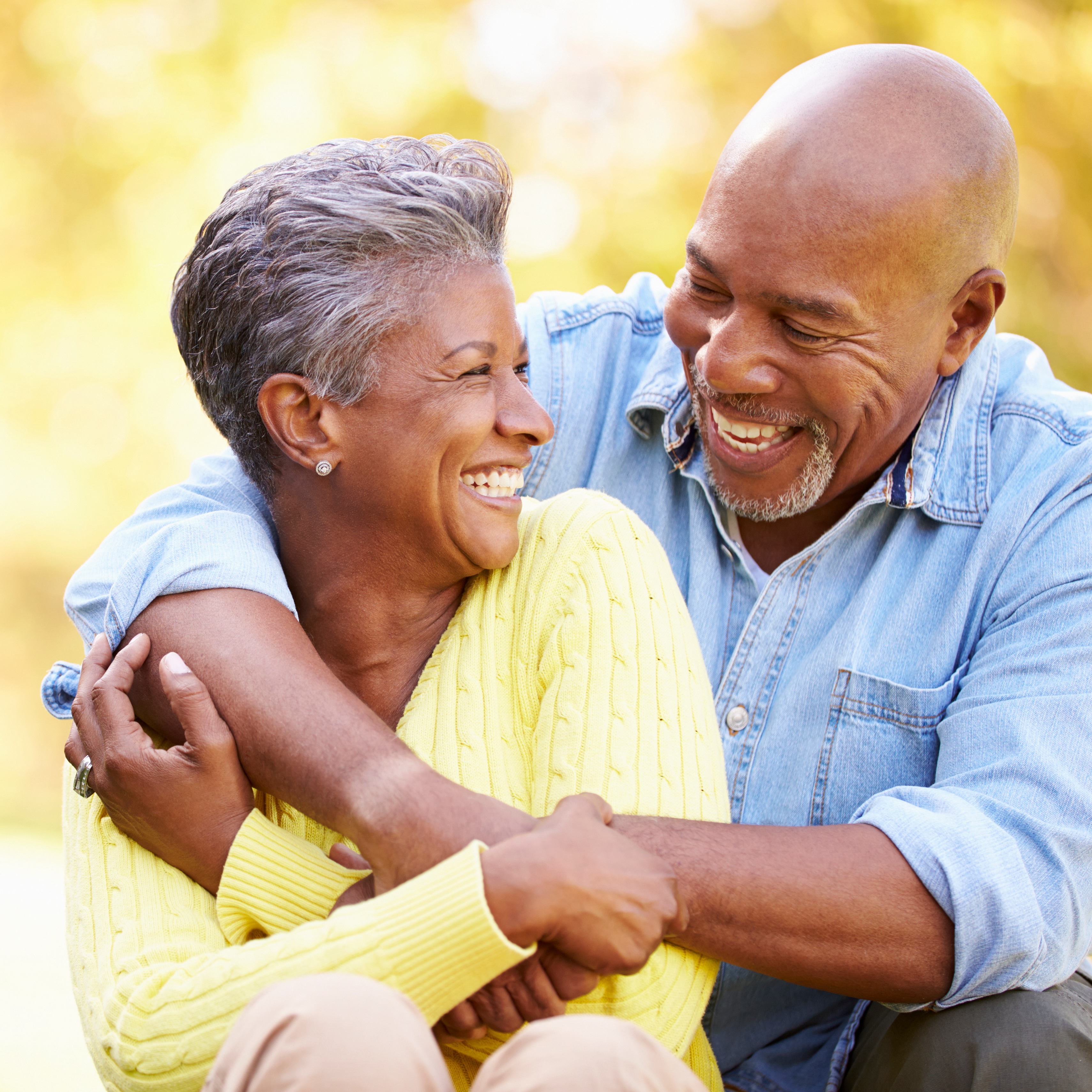 Senior Couple Relaxing In Autumn Landscape